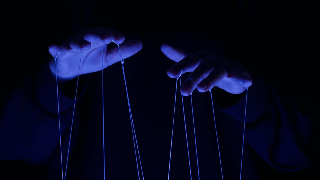 Human Hands Manipulating Strings Under Blue Light
