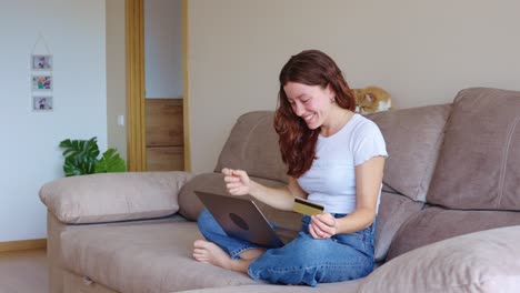 woman online shopping with credit card on laptop at home