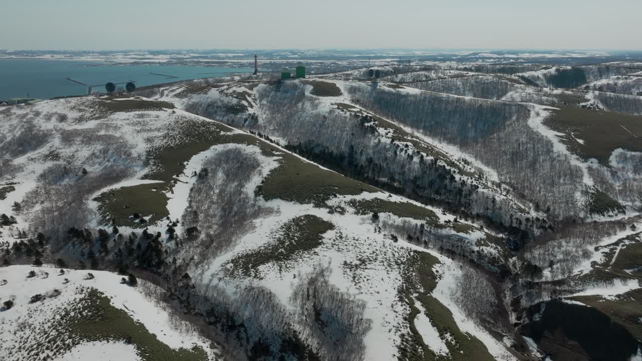 Snowy Wakkanaimura Hills During Winter In Wakkanai, Soya Subprefecture, Hokkaido, Japan. - aerial shot