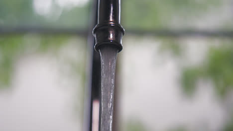 a household kitchen sink running water in slow motion