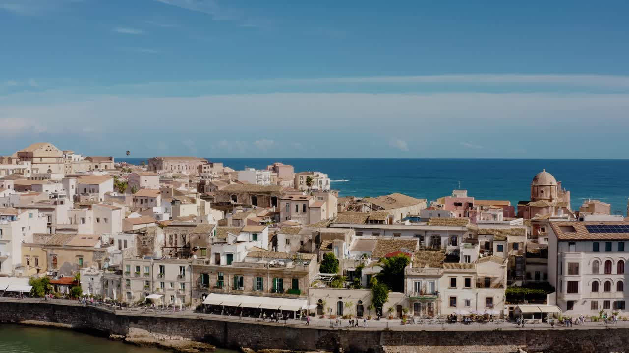 Aerial drone shot of Ortigia island. Old town in Syracuse. Historic architecture on a natural fortress by Mediterranean sea. UNESCO world heritage site in Sicily.