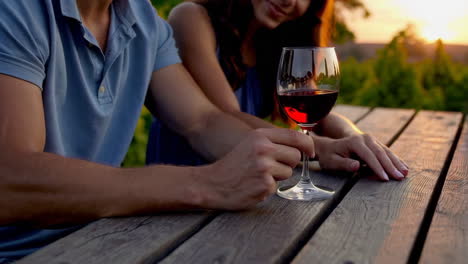 couple enjoying wine at a vineyard sunset