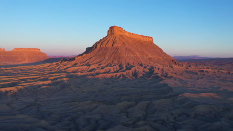 aerial rising shot of factory butte, utah