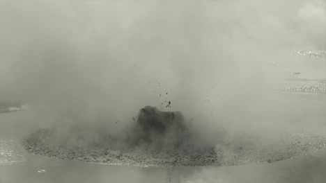 boiling hot geothermal volcanic mud pool, closeup shot steamy lake bubbling mud and steam