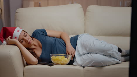 close up of woman sleeping on couch at television