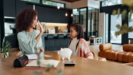 mother and daughter saving money