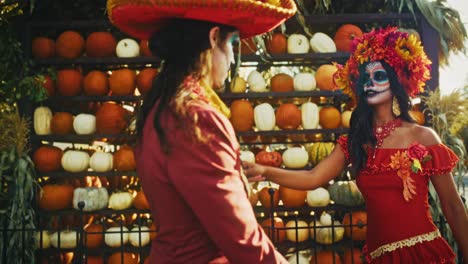 couple in day of the dead costumes at pumpkin patch
