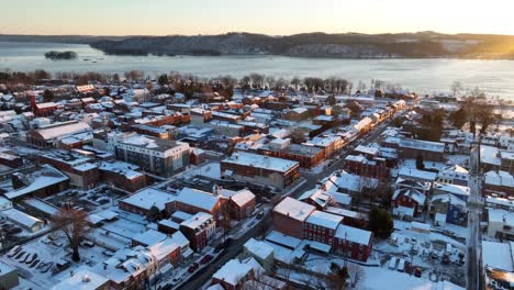 golden sunset light shining on snowy small city of america