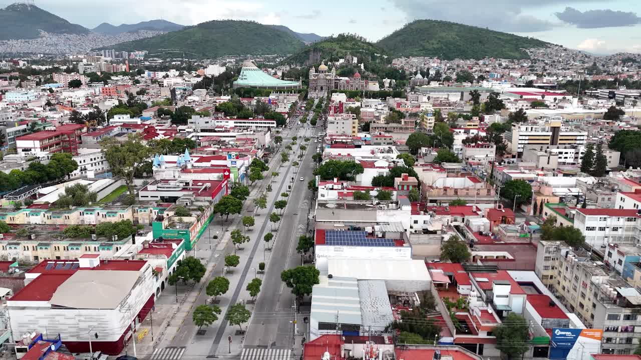 Drone flight over Misterios Avenue in the "Industrial" suburb of Mexico City, with the Basilica of Guadalupe in the background