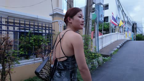 woman walking down a street in thailand