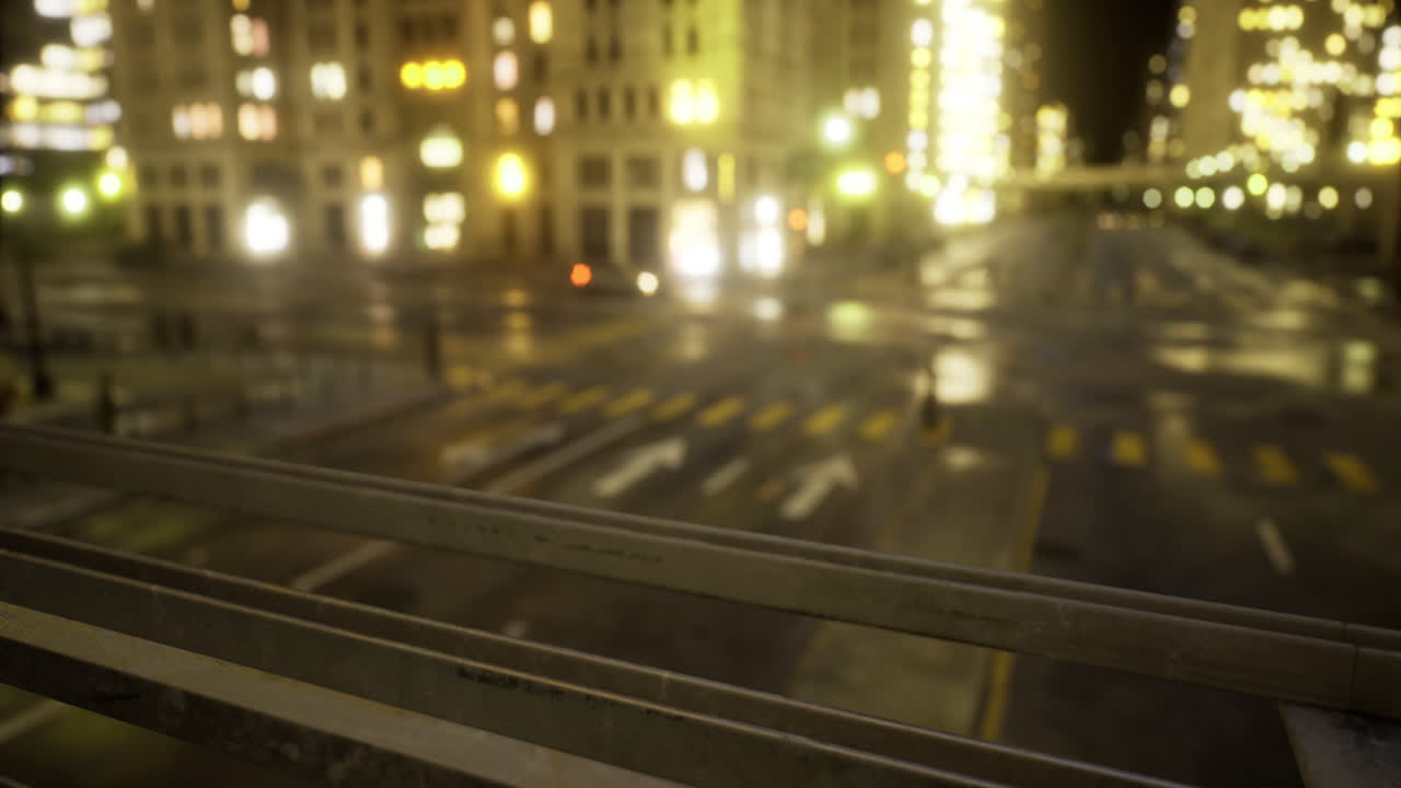 City lights shimmer under the nighttime sky as cars illuminate the streets