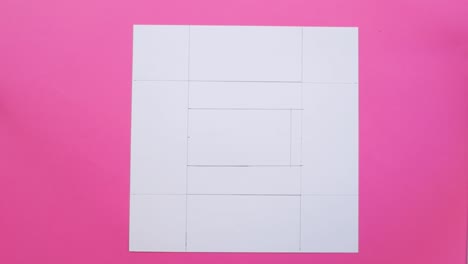 tracing letter e with paper and pencil on paper, pink background.