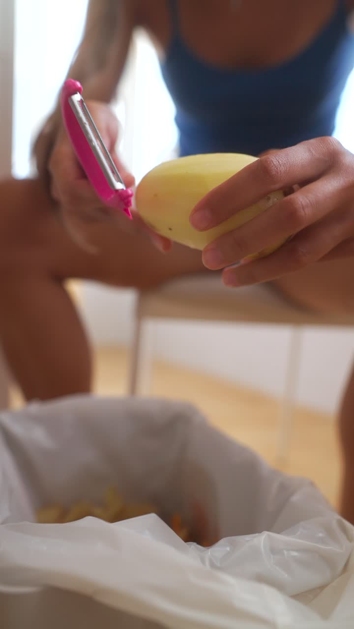 Close-up of hands peeling a potato