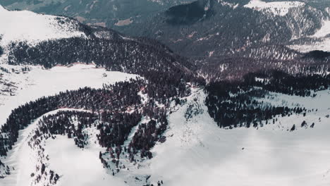 Abyss under rocky cliff and mountains in snow panorama, Dolomites