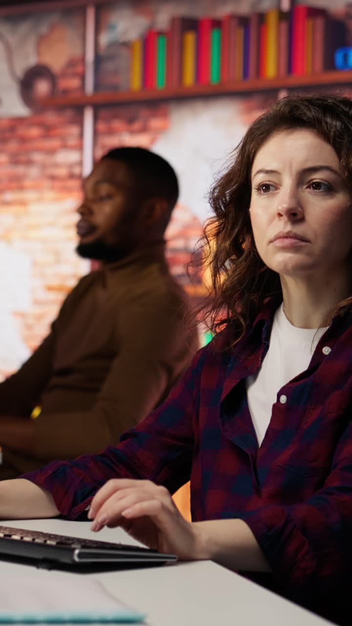 Vertical video Smiling woman using programming languages on PC in IT startup office