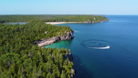 high aerial view of lake huron, a jet skier having fun circling the pristine water