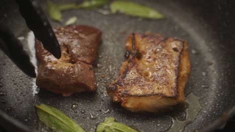 anonymous cook turning pieces of meat in frying pan