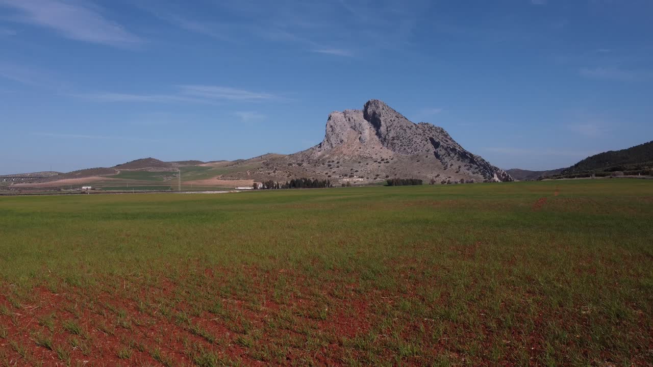 Spectacular aerial flight over the enclave of Pe&ntilde;a de los Enamorados, a rock formation in the shape of a human face in the municipality of Antequera in Andalusia, Spain