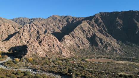 aerial pan left shot of mountain range in salta on sunny day, argentina