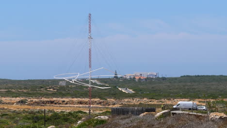 broken loran long range navigation station antenna , sunny summer day