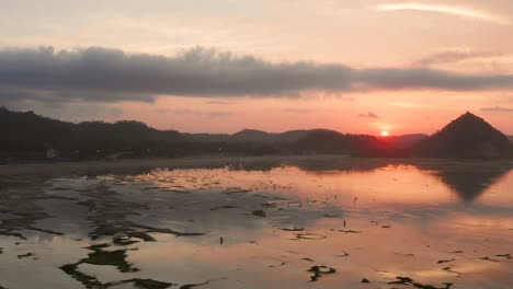 the dry reef of kuta lombok during sunrise, with local people looking for food and seashells