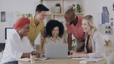 team of businesspeople using a laptop in an office