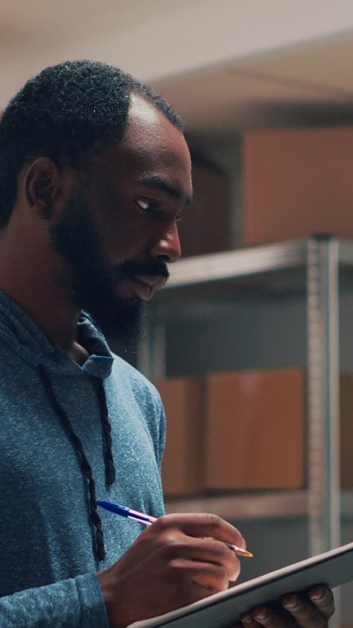 Vertical video: African american owner working on stock inventory