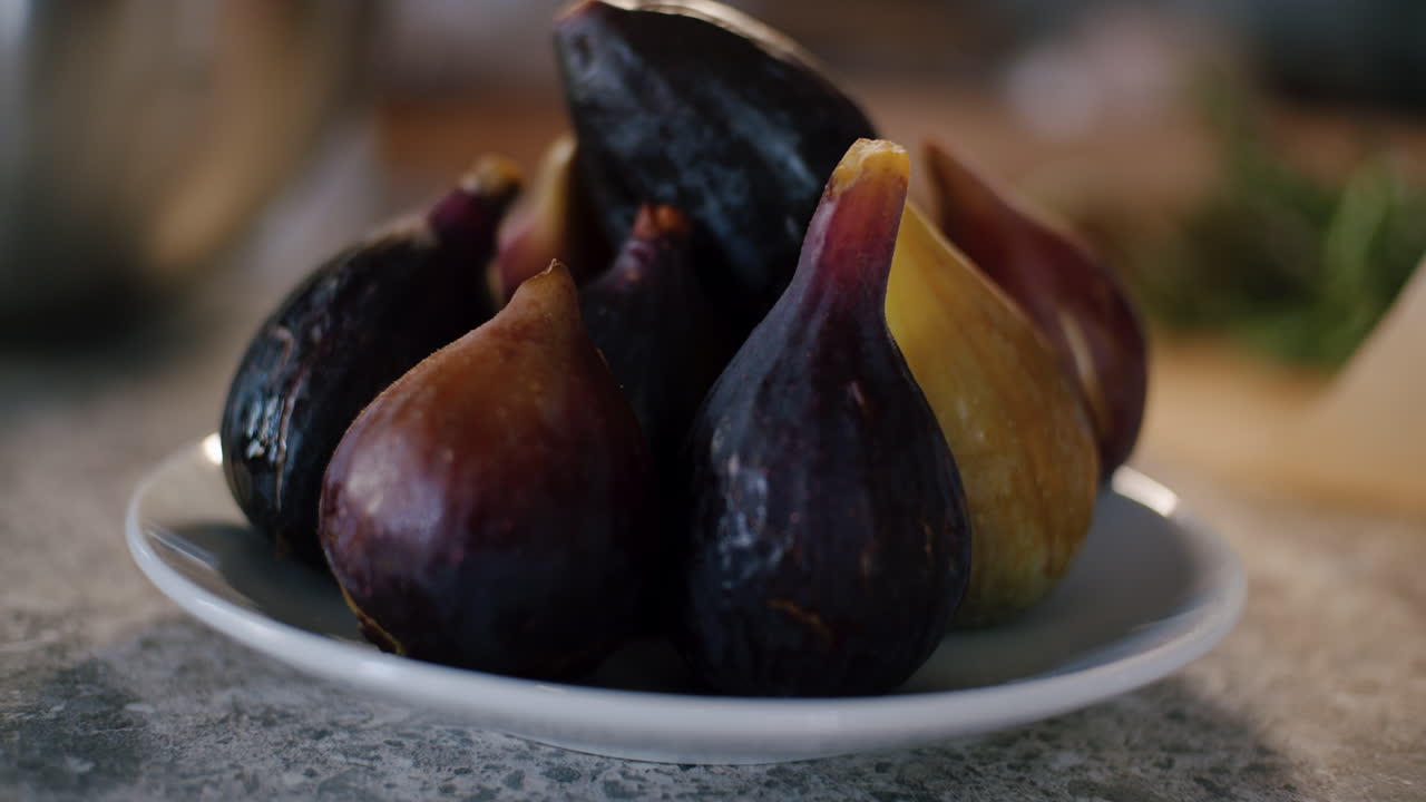 Fig bulbs on the elegant white plate indoors, rack focus