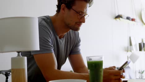 man using mobile phone in living room 4k