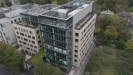 Aerial view of a large vacant office building with modern design elements and rooftop installations, Ealing, London, UK, October 2024