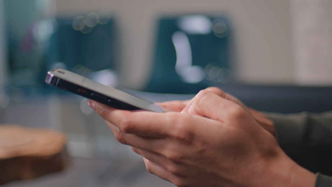 Closeup businesswoman hands texting on smartphone at office. Female messaging