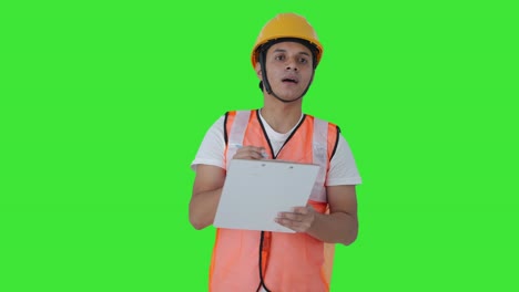 Serious-Indian-construction-labour-writing-notes-Green-screen