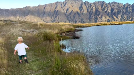 toddler strolling along a lord of the rings filming location and deer park heights in queenstown new zealand