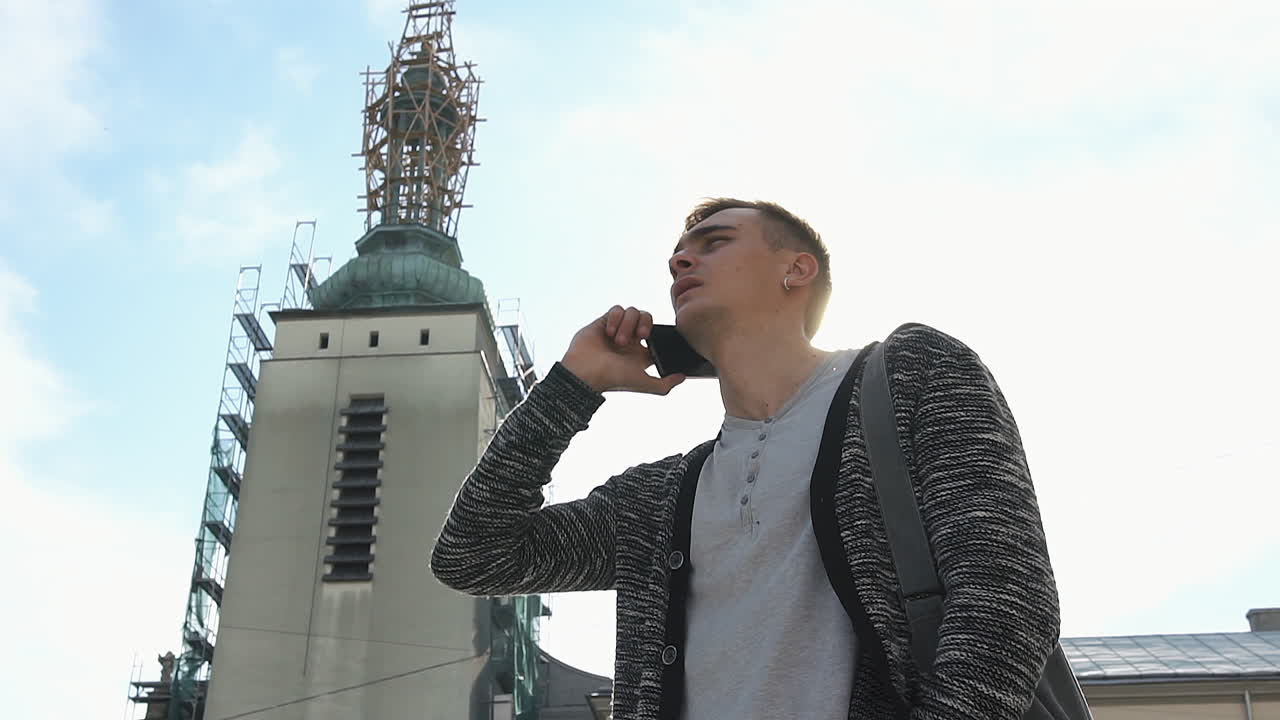 Man talking on cellphone near church