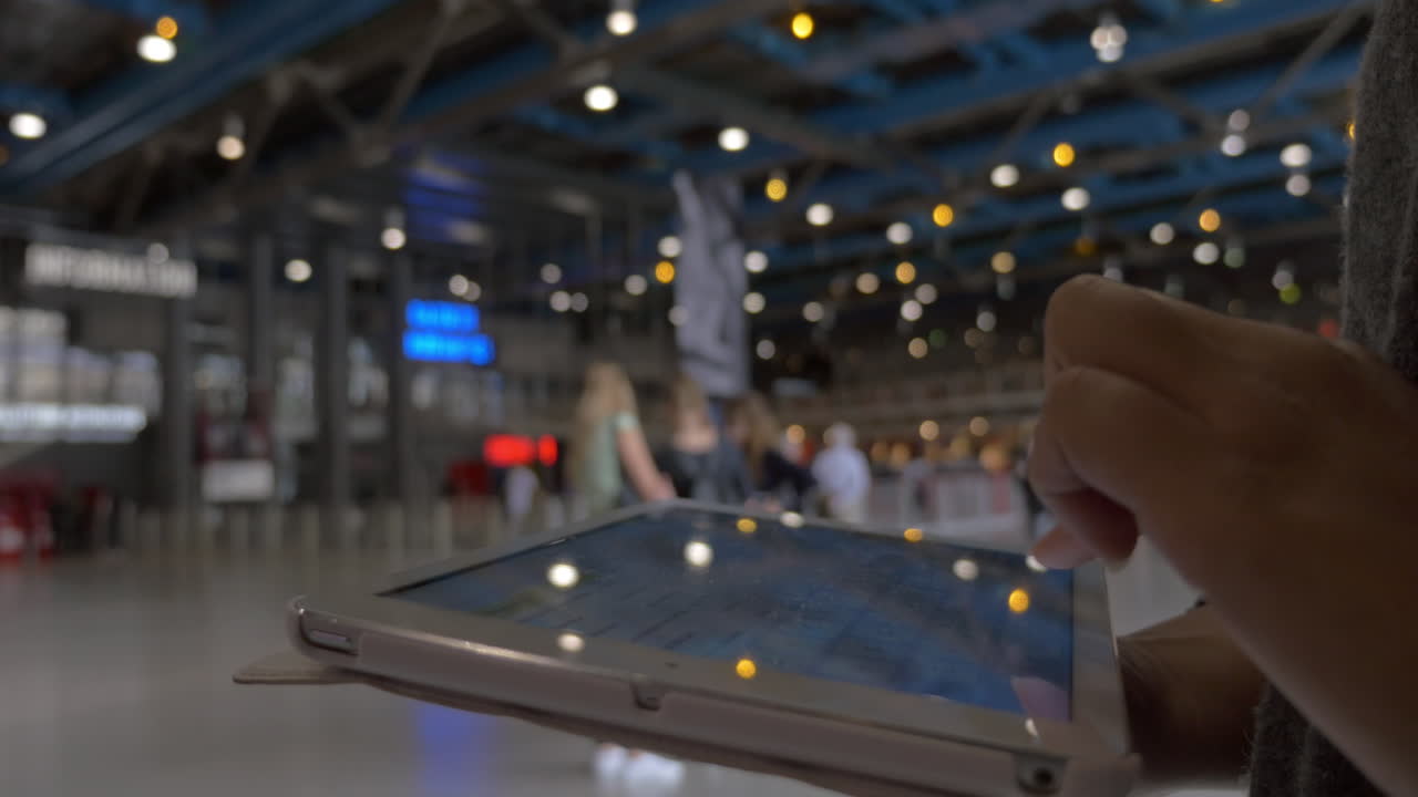 쇼핑 센터 홀 에서 태블릿 pc 에서 타이핑 하는 여자