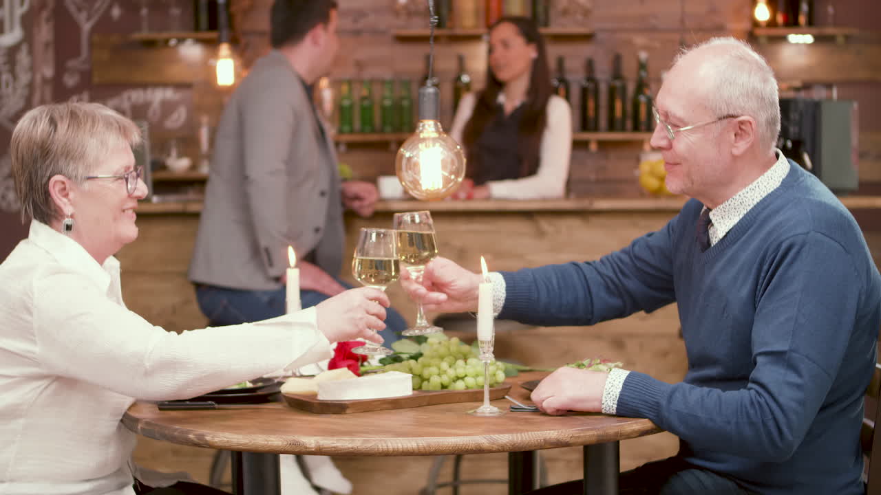 Elderly couple enjoying a romantic dinner in a restaurant