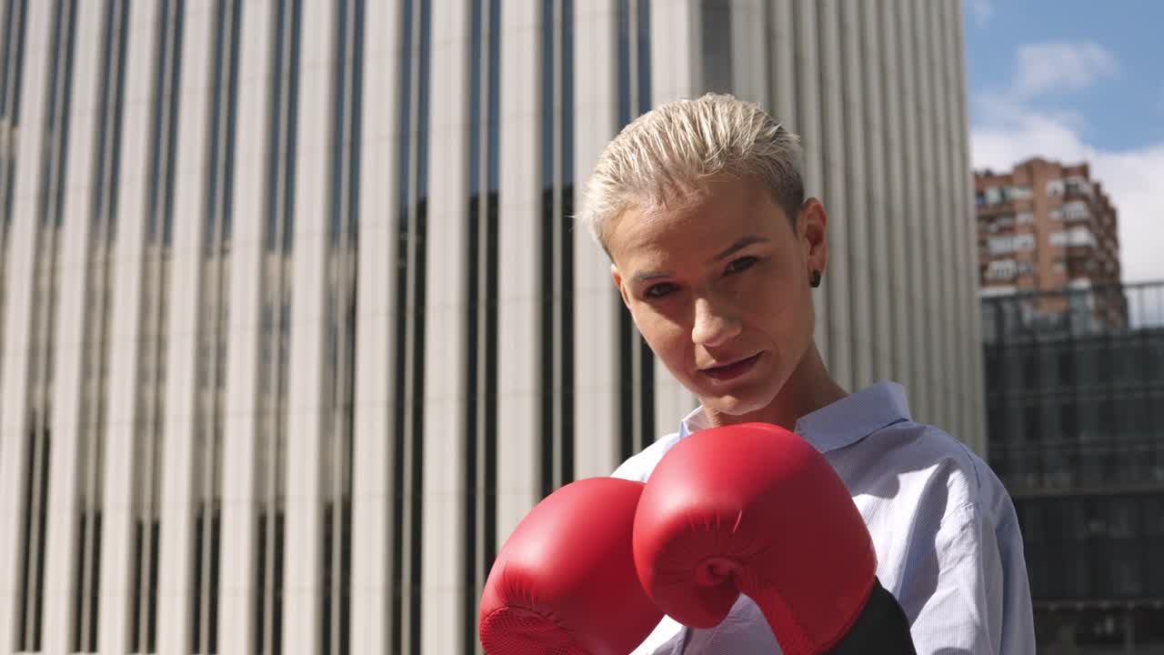 Woman with red boxing gloves in the city