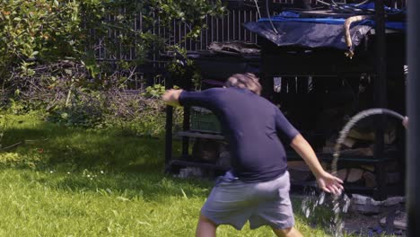 laughing children enjoy water fight fun with garden hose in summer