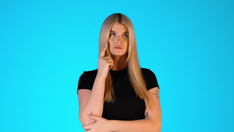 blonde woman thinking, thoughtful doubtful uncertain gesture, studio portrait