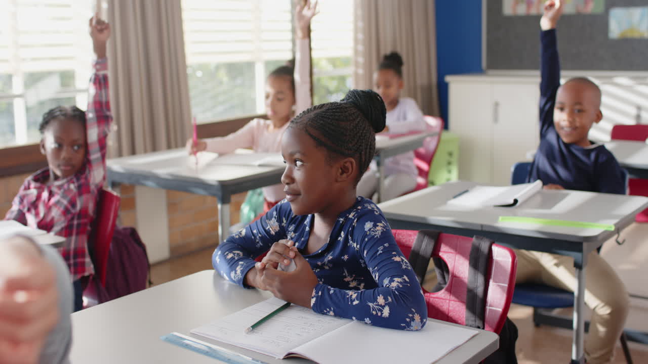 In school, students raising hands and participating in classroom discussion