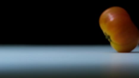 Big-beefsteak-tomato-rolling-into-the-frame-in-slow-motion