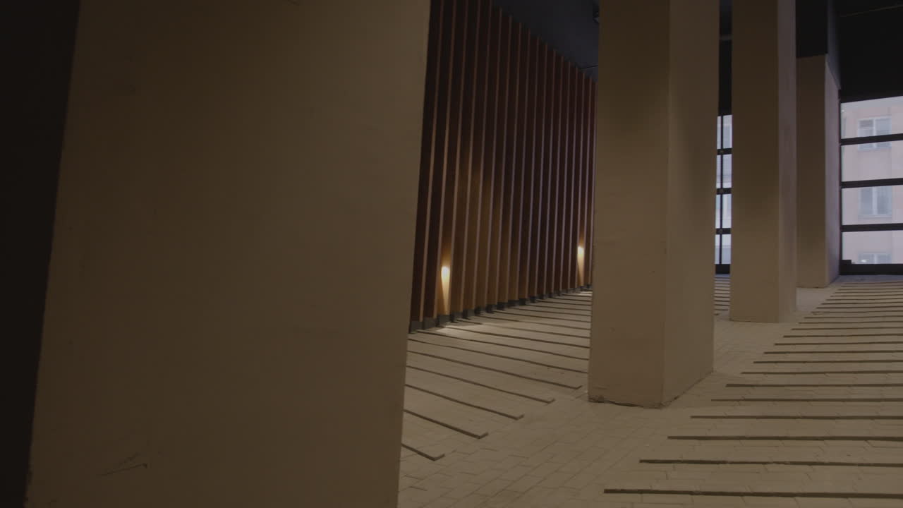 Modern Interior Corridor with Wooden Panels and Concrete Columns
