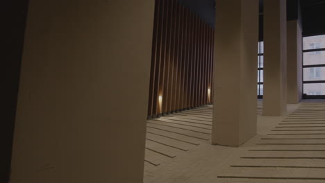 modern interior corridor with wooden panels and concrete columns