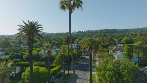 aerial drone shot of luxurious beverly hills neighborhood on a sunny california day