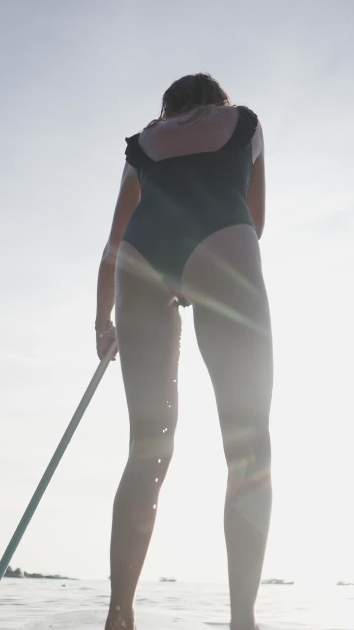 Woman paddleboarding on a sunny day