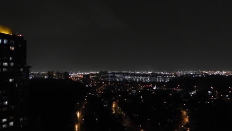 toronto skyline lit up by thunder during a storm, with city lights glowing below