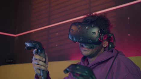 close up view of boy playing video games wearing virtual reality glasses and using gamepads sitting on sofa at home 1