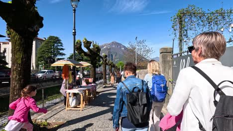 people strolling along a scenic lakeside path