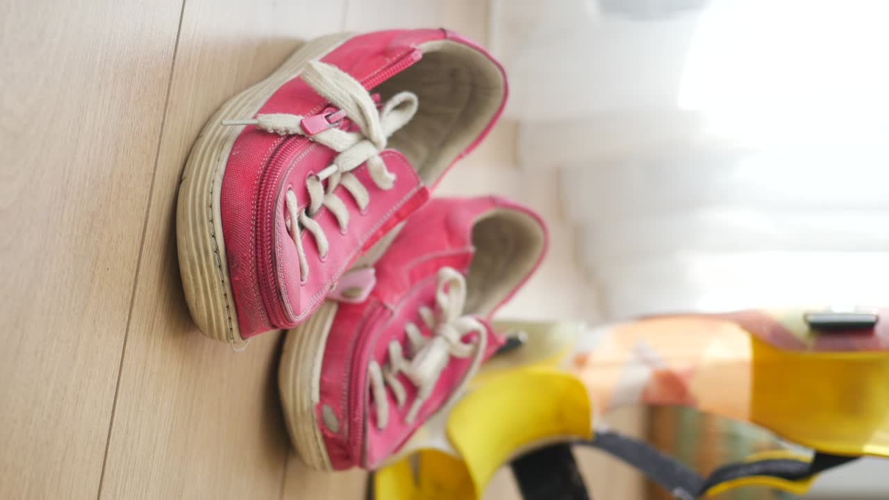 Pink sneakers on a wooden floor
