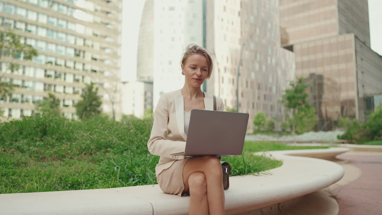 Businesswoman Working on Laptop Outdoors